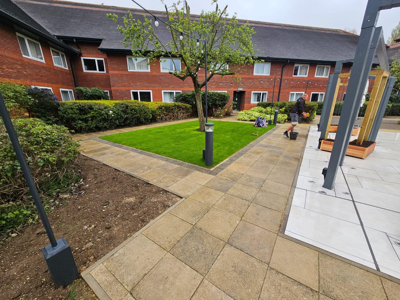 Commercial courtyard garden with new lawn, paving and pergola by Boyde Landscaping.