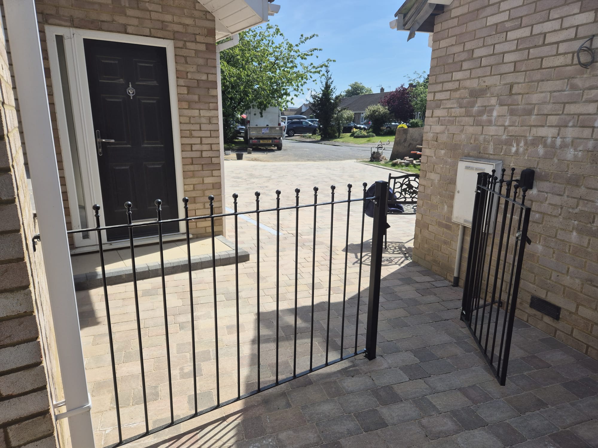 Block paving driveway with iron railings by Boyde Landscaping.